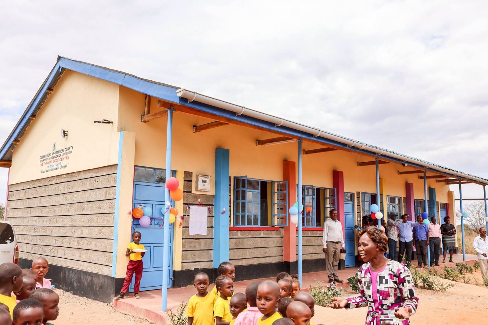 Pupils in yellow T-shirts outside the newly built Methovini ECDE Centre